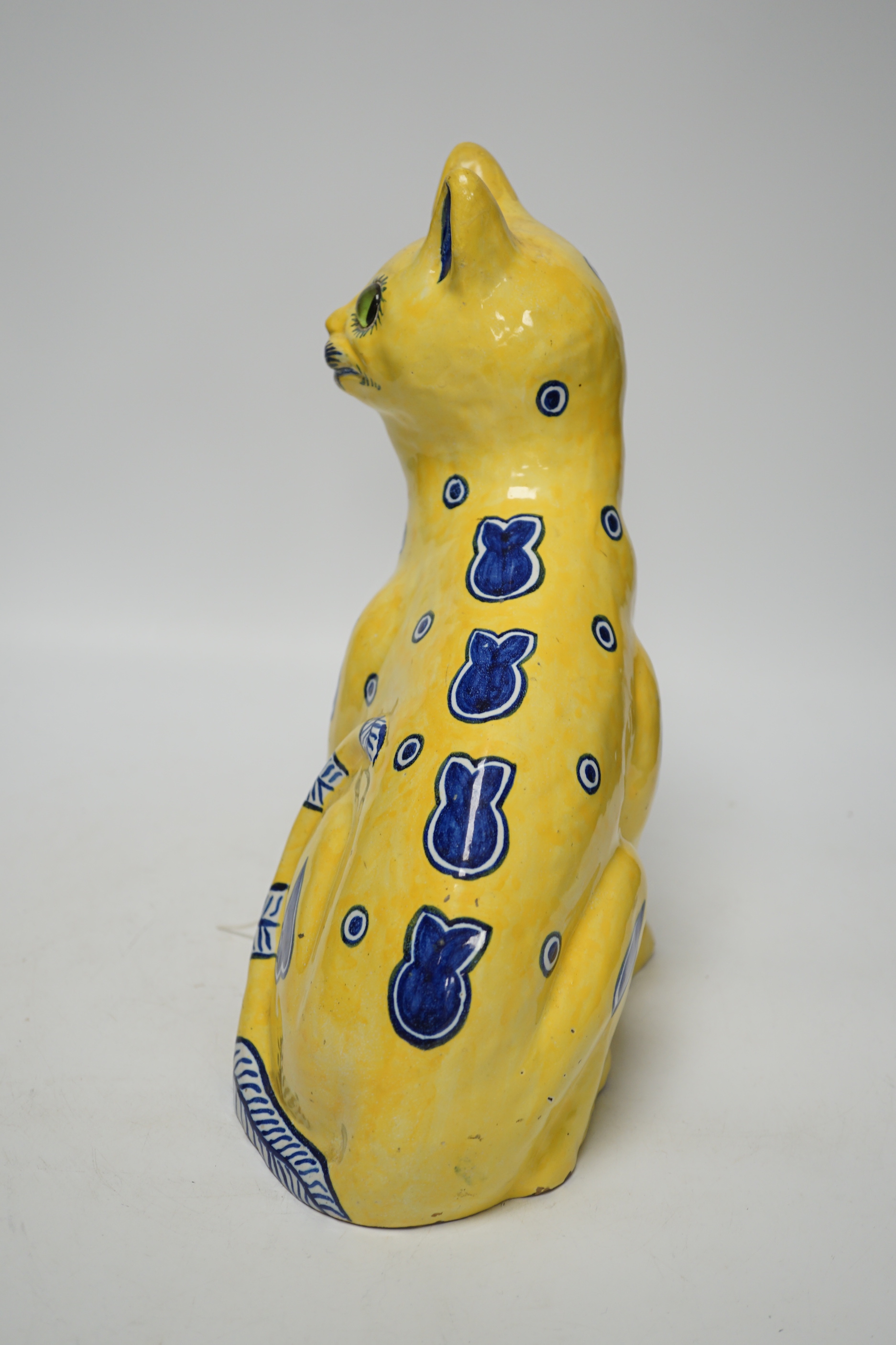 A Mosanic Galle style faience seated cat with glass eyes, c.1900-10, 31cm